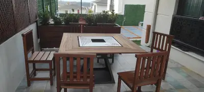 a wooden table and two chairs on a patio at family villas 2 in Sapanca