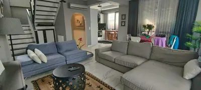 a living room with two couches and a staircase at family villas 2 in Sapanca