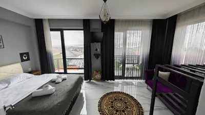 a bedroom with a bed and a balcony at family villas 2 in Sapanca