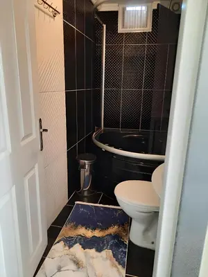 a bathroom with a toilet and a bath tub at Apart La Mia in Istanbul