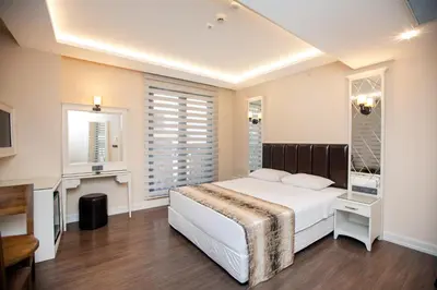 a bedroom with a large white bed and a window at PRAG HOTEL in Istanbul