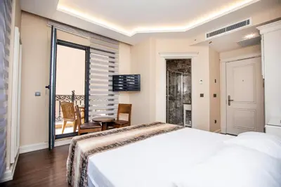 a bedroom with a bed and a balcony at Opatija Hotel in Istanbul