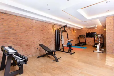 a gym with a brick wall and exercise equipment at Opatija Hotel in Istanbul