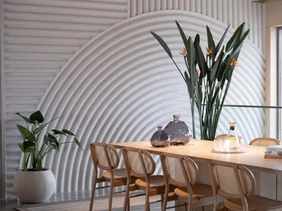 a dining room table with chairs and a vase with flowers at İnemare Hotel in Demirköy