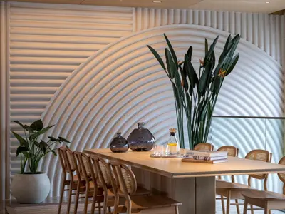 a table with chairs and a vase with flowers on it at İnemare Hotel in Demirköy