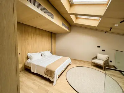 a bedroom with a large bed and a chair at İnemare Hotel in Demirköy