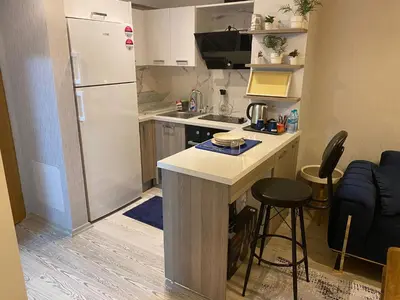 a small kitchen with a counter and a refrigerator at Classic Suite MK1 in Istanbul