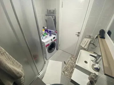 a small bathroom with a washing machine and a sink at Classic Suite MK1 in Istanbul