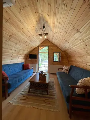 a living room with blue couches and a wooden ceiling at Villa Nora Butik Otel ve Bungalov in Bursa