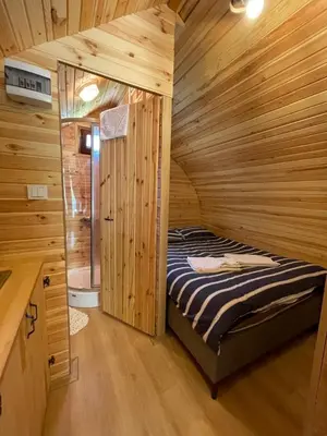 a bedroom with a bed in a wooden cabin at Villa Nora Butik Otel ve Bungalov in Bursa