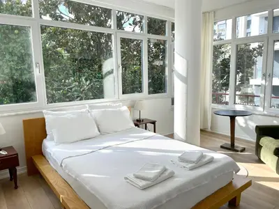 a bedroom with a large bed with two towels on it at Petek Pansiyon Fenerbahce Kadikoy in Istanbul