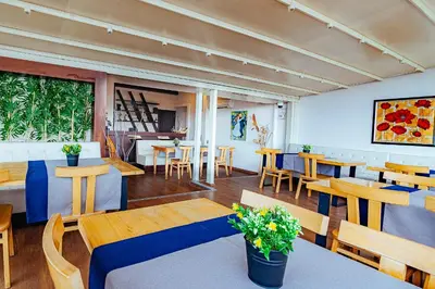 a restaurant with wooden tables and chairs and a room at The Milltown Hotel in Istanbul