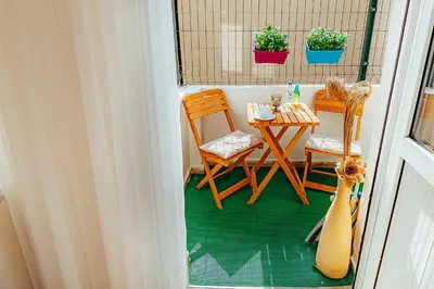 a small balcony with a table and two chairs at The Milltown Hotel in Istanbul