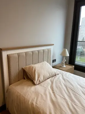a bedroom with a bed with a pillow and a window at Luxury Central Fully Equipped 2BR 2BA Apartment by Siena Suites in Istanbul
