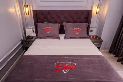 a bedroom with a bed with a harley davidson blanket at Ruby Hotel in Istanbul
