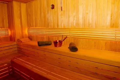 a wooden sauna with a bucket and two mitts at Business Life Hotel & SPA Bakırköy in Istanbul