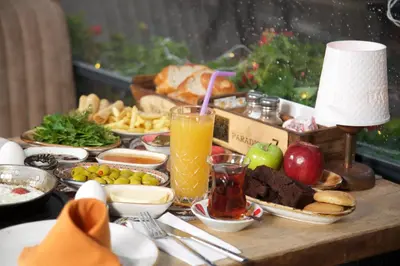 a table topped with plates of food and a drink at La Vida Old City Hotel in Istanbul