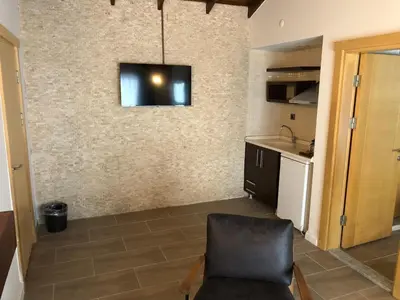 a living room with a television on a wall at Masklavi in Kestel