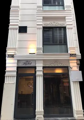 a white building with columns on the side of it at Mina Life Hotel in Istanbul