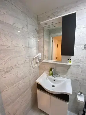 a bathroom with a white sink and a mirror at Mina Life Hotel in Istanbul