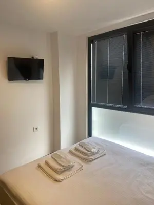 a bed with two towels on it with a window at Mina Life Hotel in Istanbul