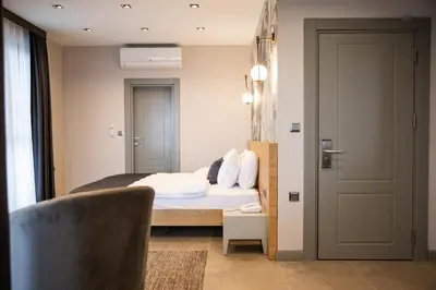 a bedroom with a bed and a chair and a door at Kartepe Panorama in Kartepe