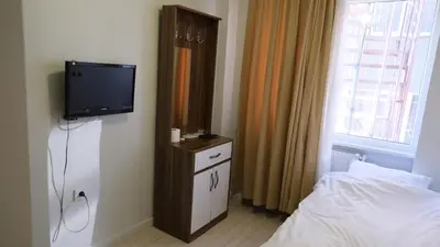 a bedroom with a bed and a tv on a wall at Simon Hotel in Istanbul