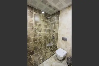 a bathroom with a toilet and a shower at Taksim Cihangir Fidan Residence Hotel in Istanbul
