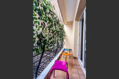 a room with two pink chairs and a plant on a wall at Taksim Cihangir Fidan Residence Hotel in Istanbul