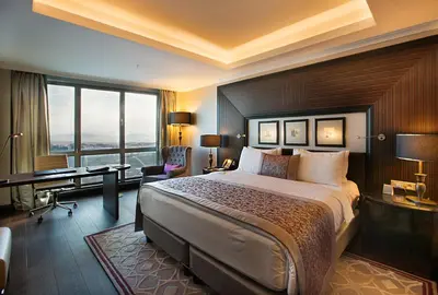 a hotel room with a large bed and a desk at Dedeman Bostanci Istanbul Hotel & Convention Center in Istanbul
