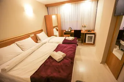 a bedroom with a bed with two towels on it at Grand İstanbul Airport Hotel in Istanbul