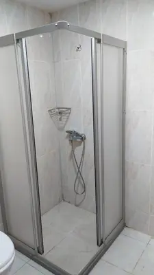 a shower with a glass door in a bathroom at Grand İstanbul Airport Hotel in Istanbul