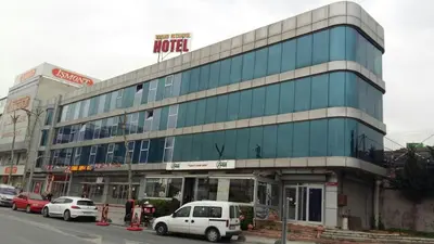 a large glass building with cars parked in front of it at Grand İstanbul Airport Hotel in Istanbul
