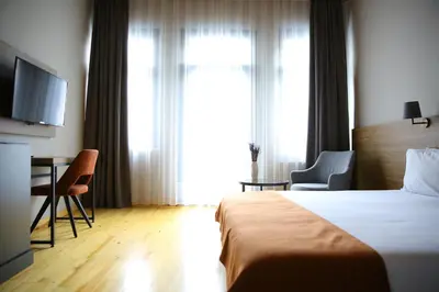 a hotel room with a bed and a desk and a television at ROCO Beyoglu in Istanbul