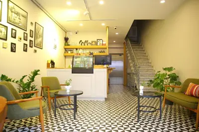 a lobby with chairs and a table and stairs at ROCO Beyoglu in Istanbul