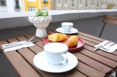 a table with two plates of food and coffee cups at ROCO Beyoglu in Istanbul