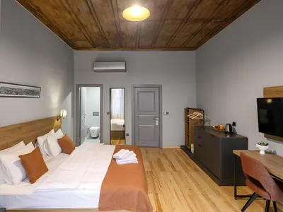 a bedroom with a large white bed and a desk at ROCO Beyoglu in Istanbul