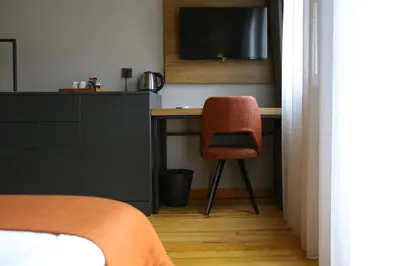 a bedroom with a desk with a chair and a television at ROCO Beyoglu in Istanbul