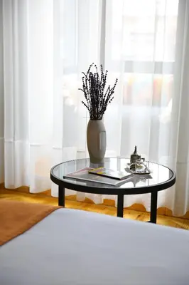 a glass table with a vase on top of it at ROCO Beyoglu in Istanbul