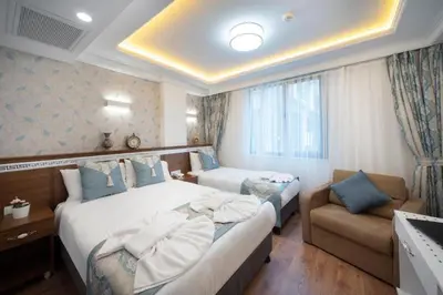 a hotel room with two beds and a couch at Lika Hotel - Standard Double or Twin Room in Istanbul