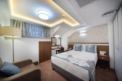 a bedroom with a bed and a couch in a room at Lika Hotel - Eco Double Room - Center Istanbul in Istanbul