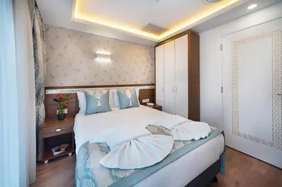 a bedroom with a large bed with pillows on it at Lika Hotel - Superior Double or Twin Room in Istanbul