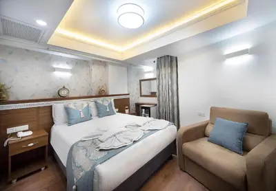 a hotel room with a bed and a chair at Lika Hotel - Eco Double Room in Istanbul