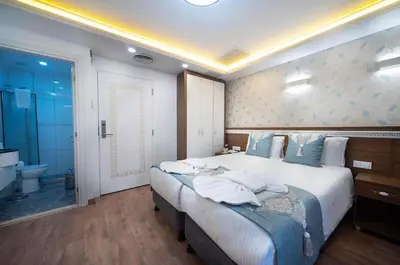 a bedroom with a large bed and a bathroom at Lika Hotel - Superior Double or Twin Room - Luxury in Istanbul Center in Istanbul