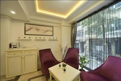 a living room with chairs and a table and a large window at Lika Hotel - Superior Double or Twin Room - Luxury in Istanbul Center in Istanbul