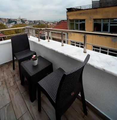 two chairs and a table on a balcony at Lika Hotel - Superior Double or Twin Room - Luxury in Istanbul Center in Istanbul