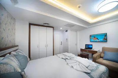 a bedroom with a bed and a chair and a desk at Lika Hotel - Comfortable Double Room in Istanbul in Istanbul