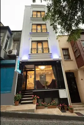 a white building with potted plants in front of it at Lika Hotel - Superior Double or Twin Room - unforgettable holiday in Istanbul in Istanbul