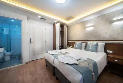 a bedroom with a large bed and a bathroom at Lika Hotel - Superior Double or Twin Room - unforgettable holiday in Istanbul in Istanbul