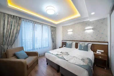a hotel room with a bed and a chair at Lika Hotel - Superior Double or Twin Room - unforgettable holiday in Istanbul in Istanbul